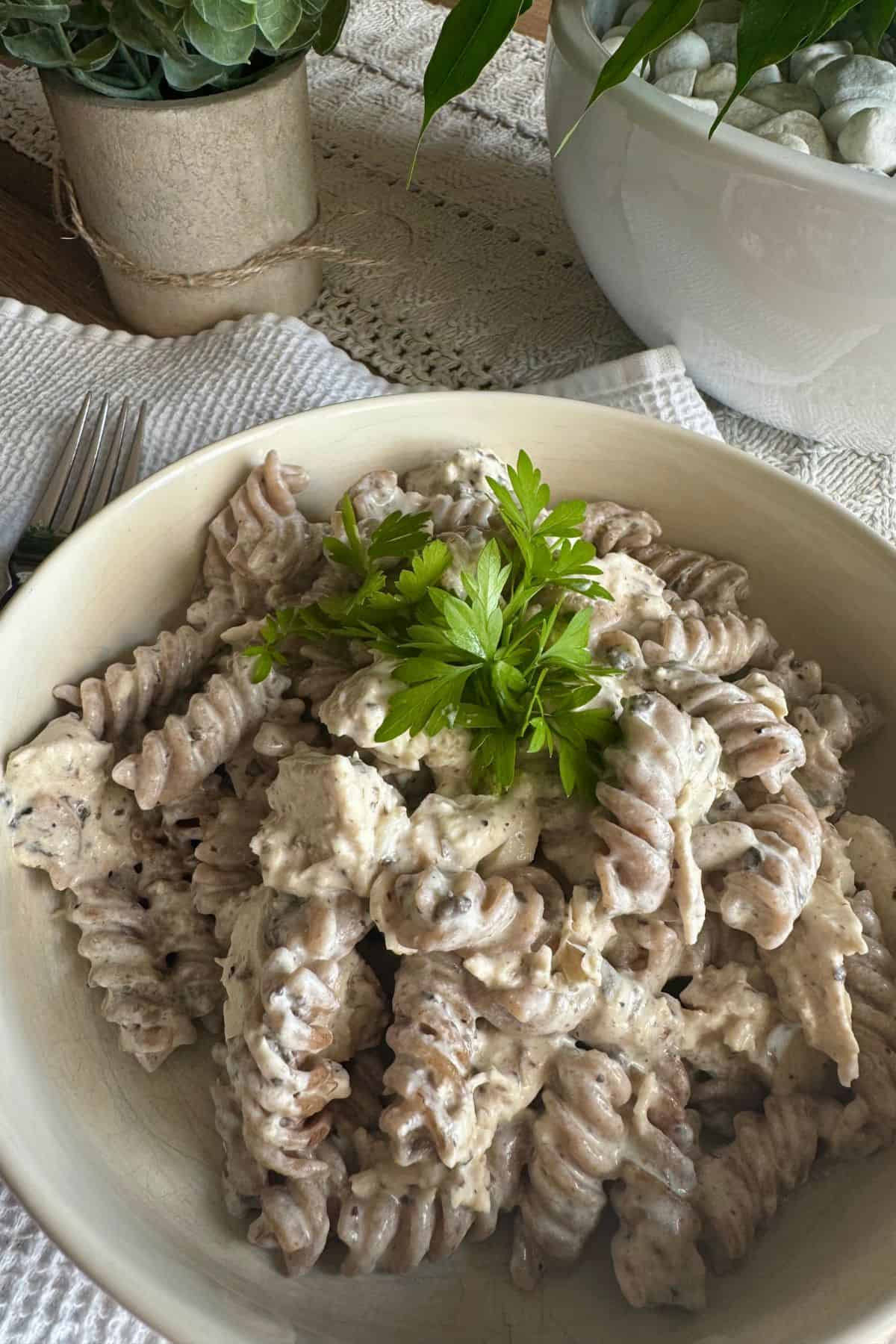 Pasta with sauce and chicken served on a plate.