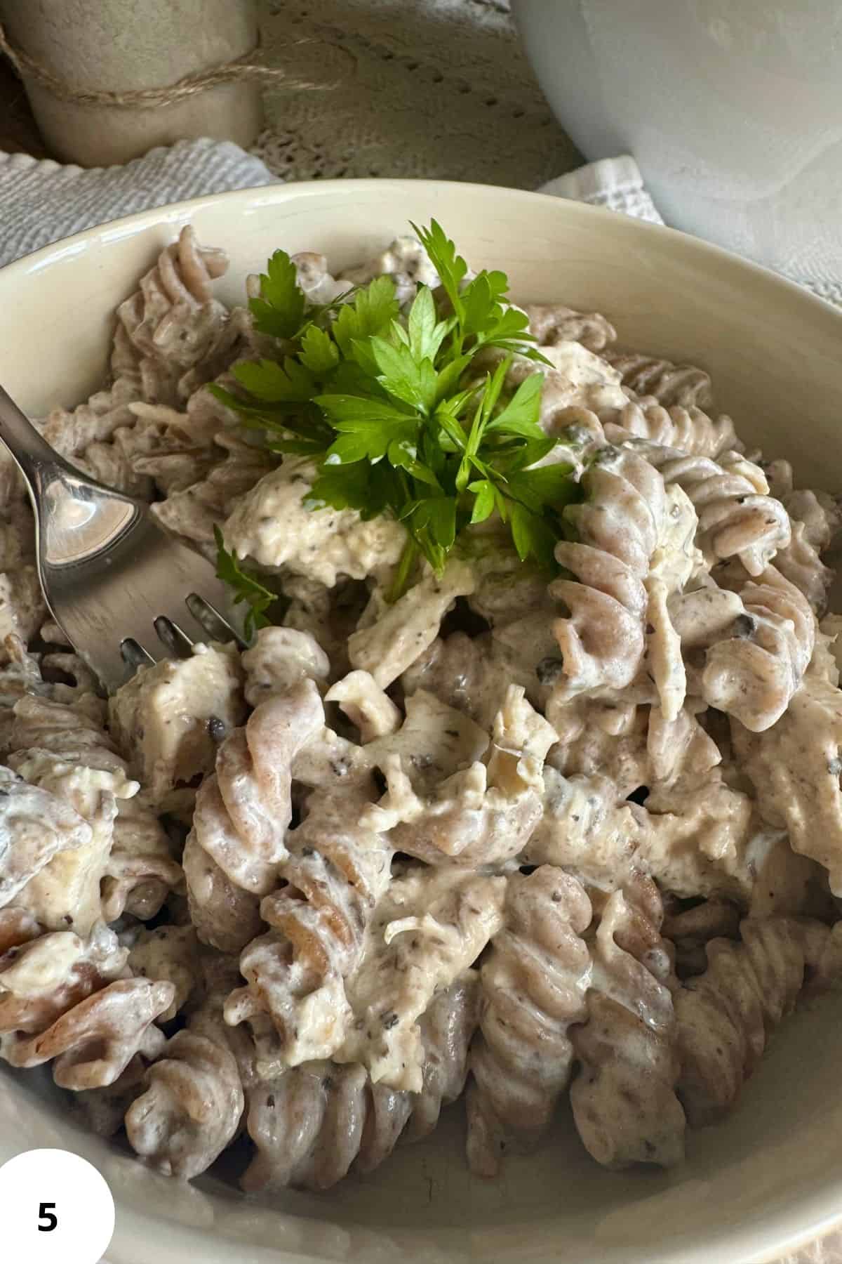 Pasta with sauce and chicken served on a plate.