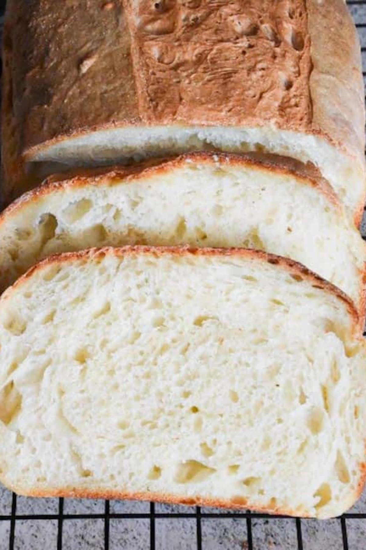 Sliced loaf of sourdough sandwich bread with milk, showing its soft, airy interior.