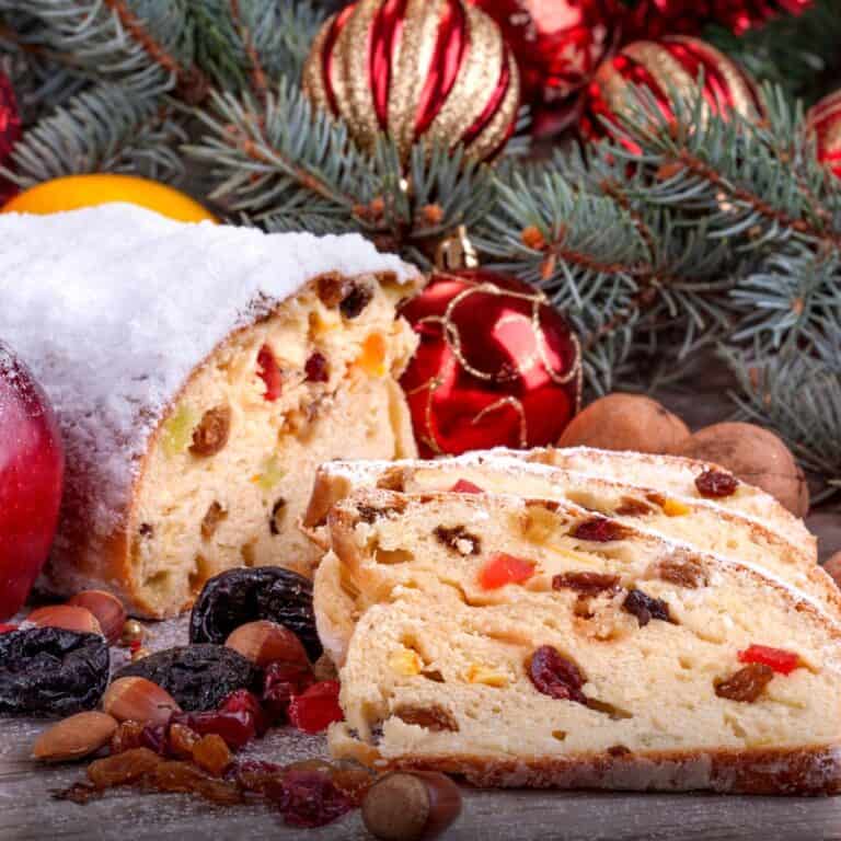 Sliced loaf with raisins showing a soft interior, set against a festive Christmas background with holiday decorations.