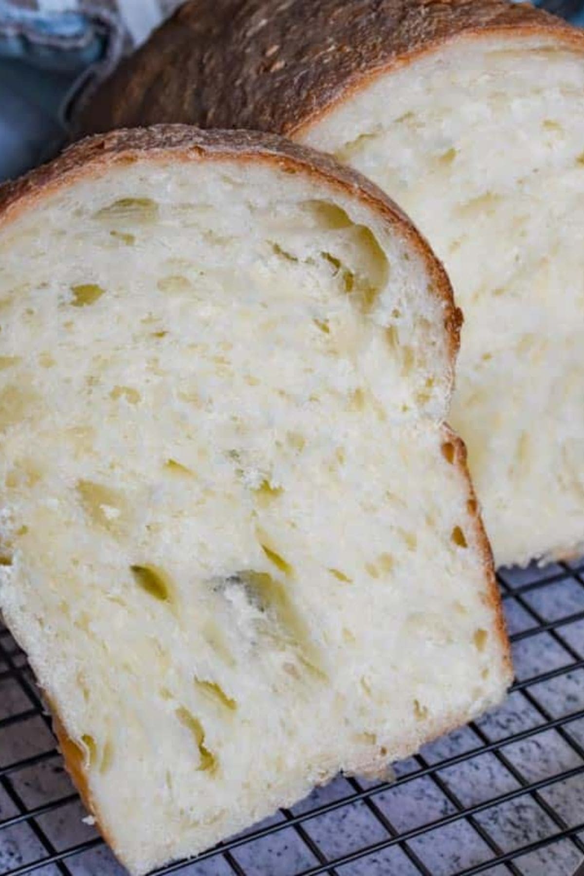 Close-up of sliced bread on a cooling rack, showing its soft and fluffy interior.