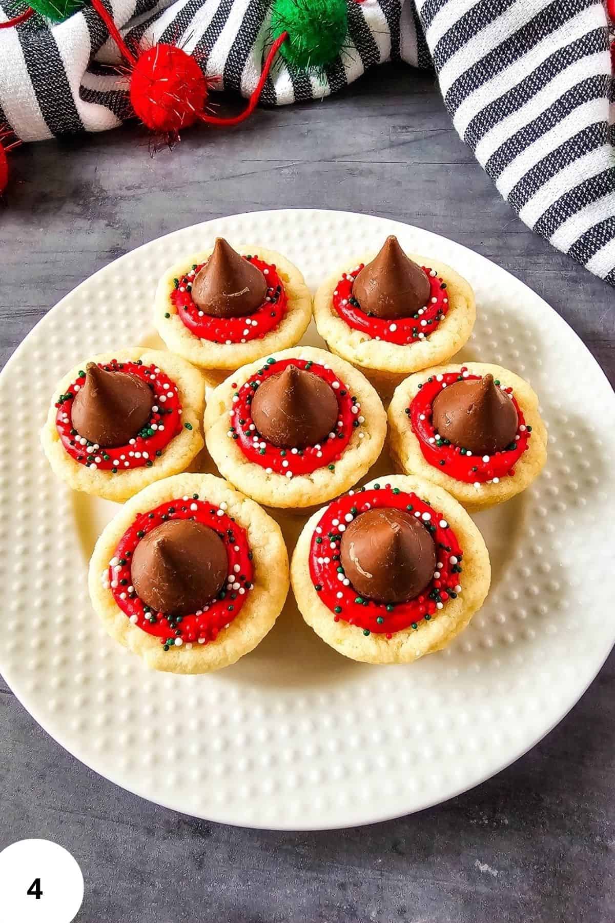 Frosted cookie cups neatly arranged on a plate, ready to serve.