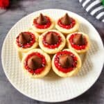 Frosted cookie cups neatly arranged on a plate, ready to serve.