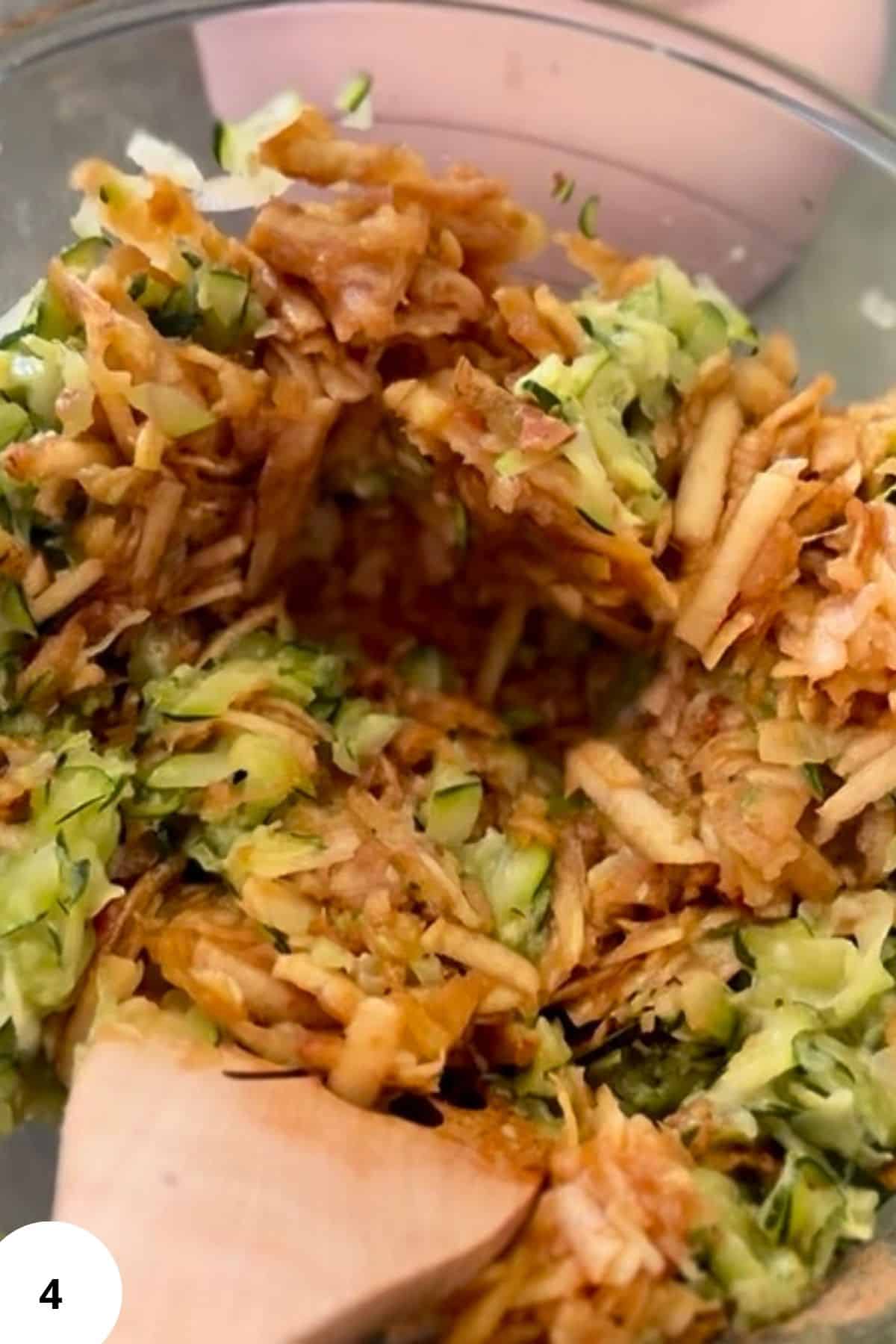 Ingredients mixed together in a bowl with a spatula resting on it.