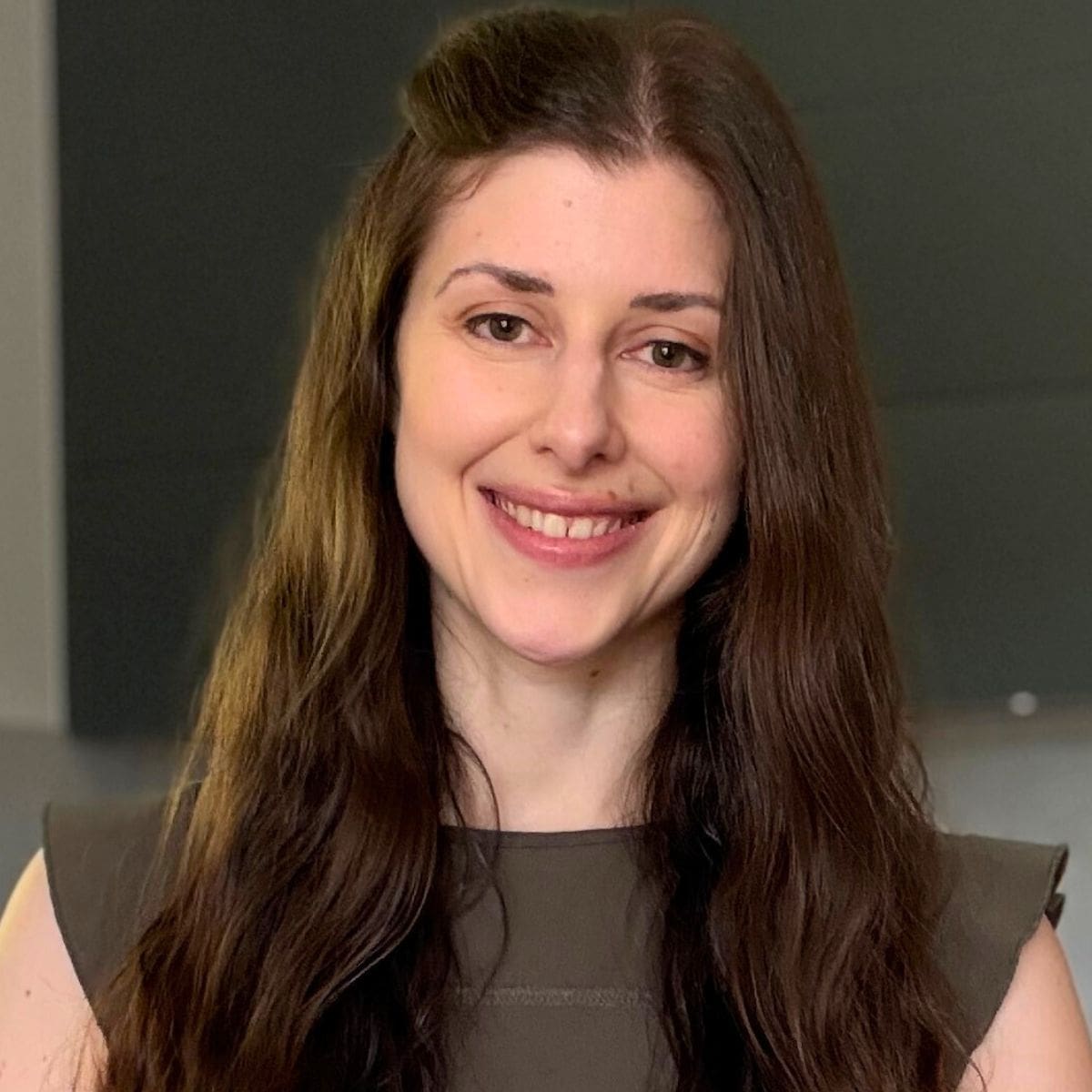 A woman smiling into the camera.