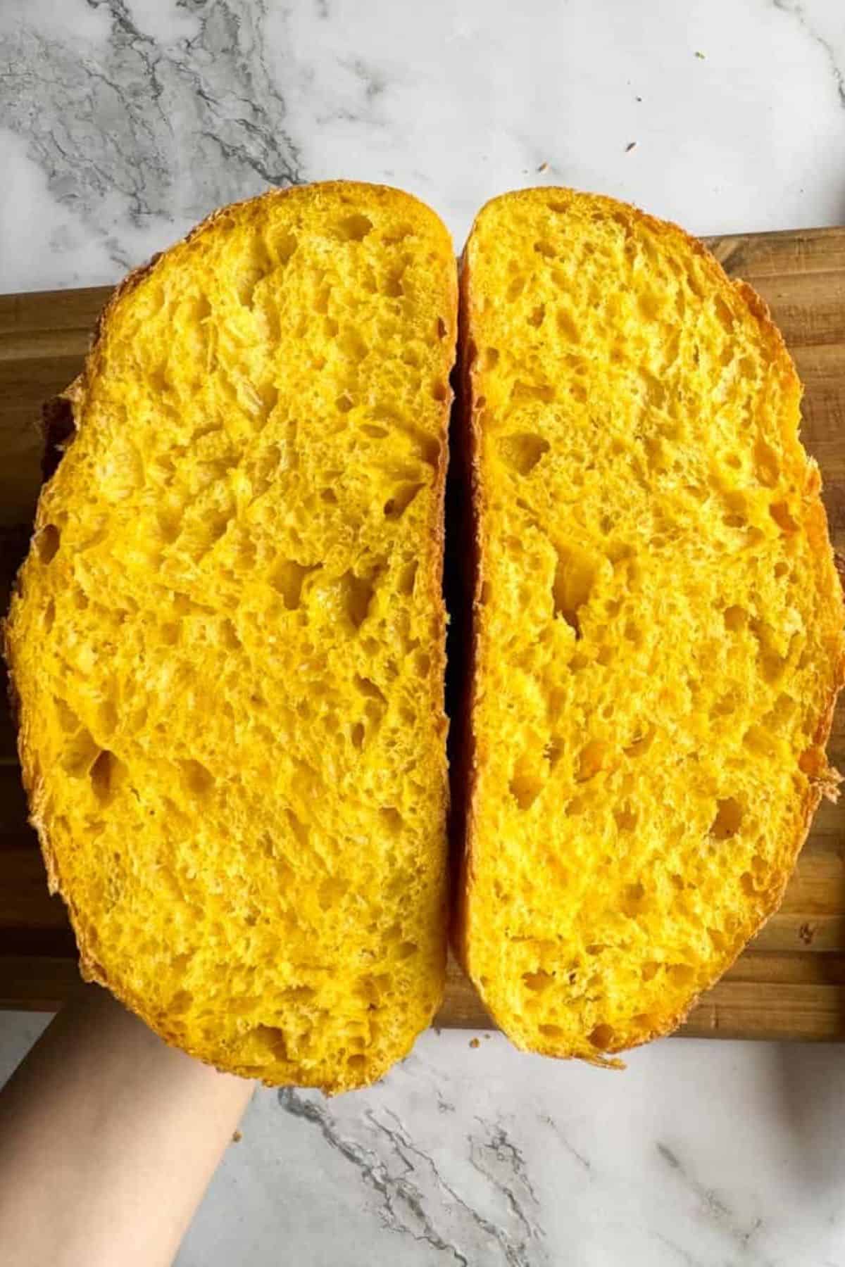 Person holding two slices of bread.