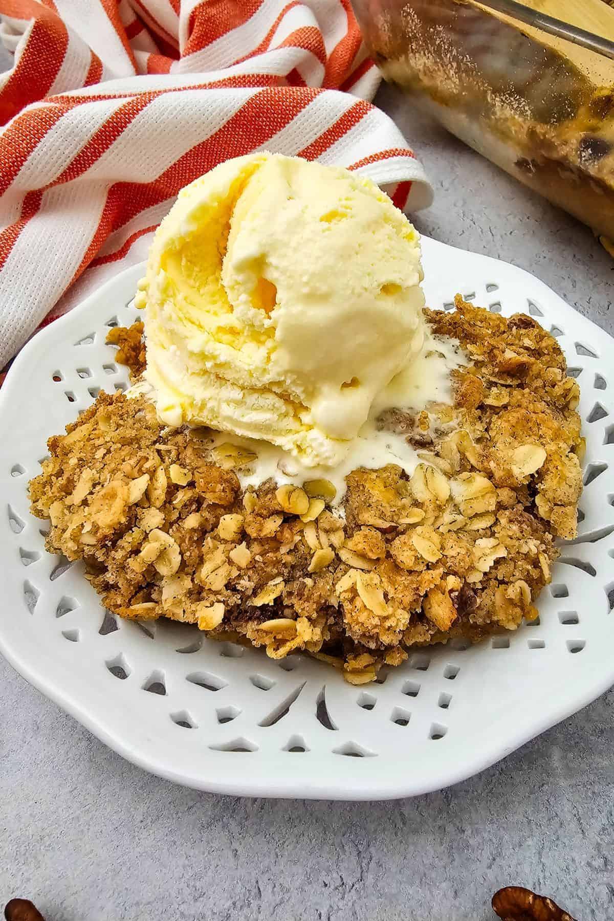 Pumpkin pie crisp topped with a scoop of vanilla ice cream.