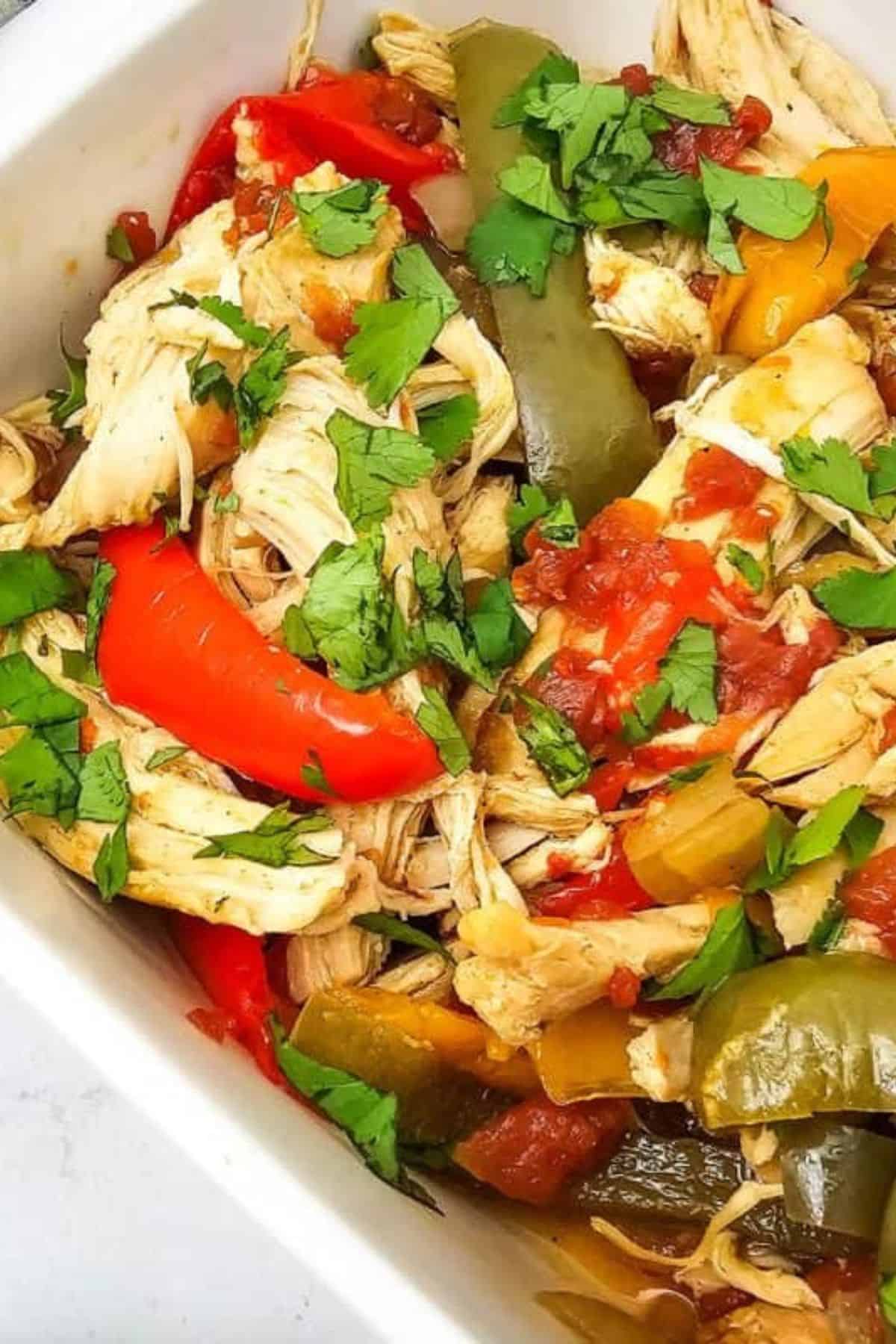 Sheet Pan Chicken Fajitas served in a dish with colorful bell peppers and onions.