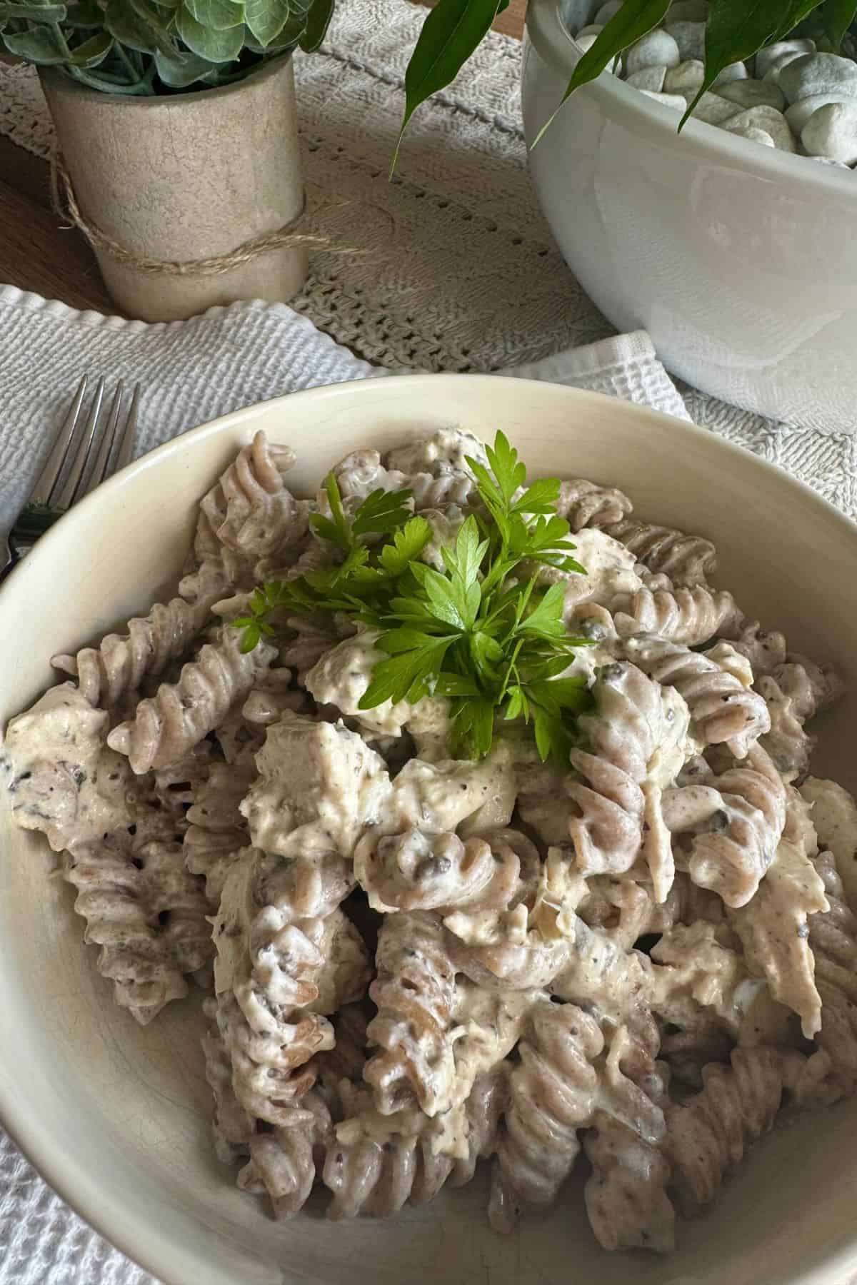 Creamy Pasta Tartufata with Chicken served on a plate, garnished with fresh herbs and a sprinkle of grated cheese.