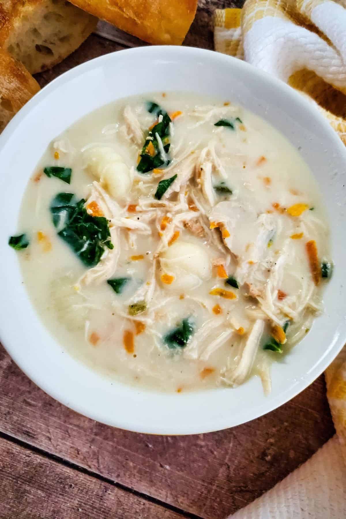 Crockpot Chicken Gnocchi Soup served in a bowl with tender chicken, soft gnocchi, and vegetables in a creamy broth.