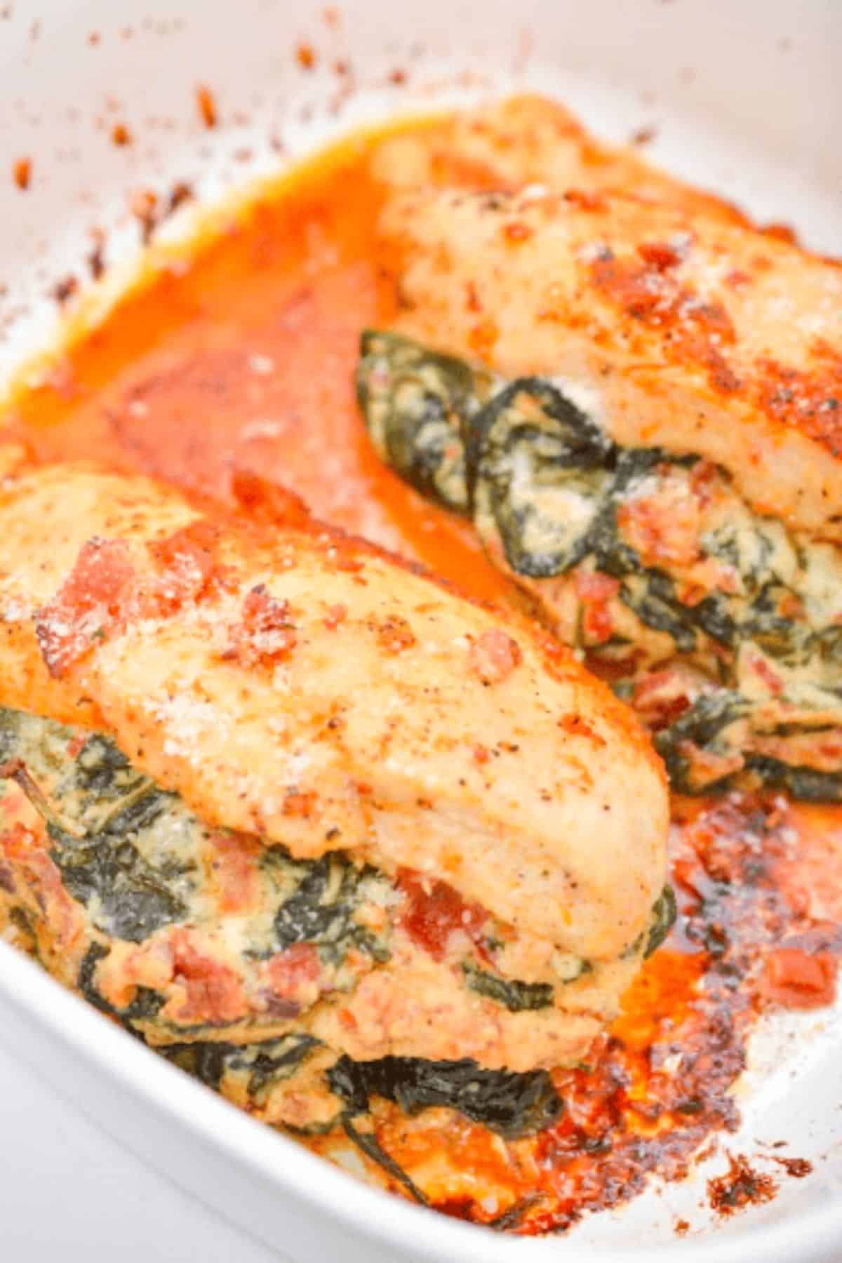 Creamed Spinach Stuffed Chicken on a plate, with creamy filling soaking into the tender chicken breast.