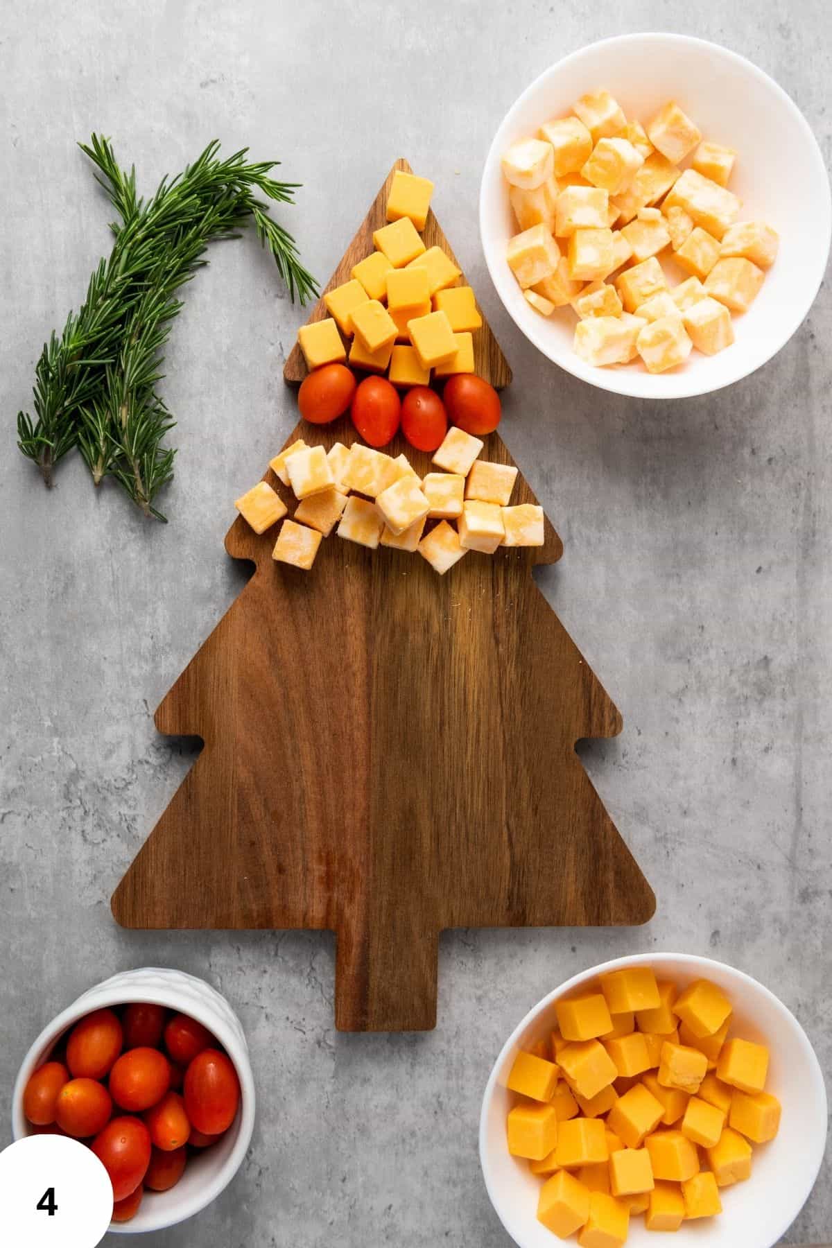 Ingredients arranged on a Christmas tree-shaped board with festive decorations around.