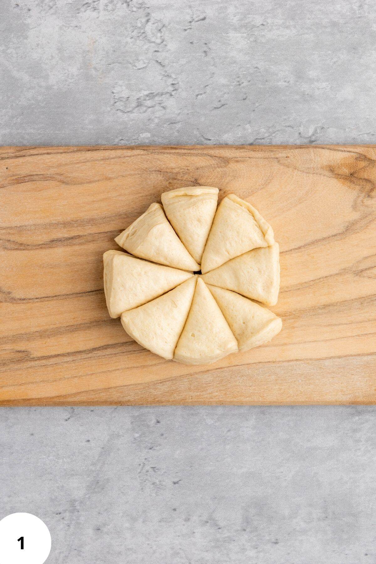 Triangular slices of bread neatly arranged on a wooden board.