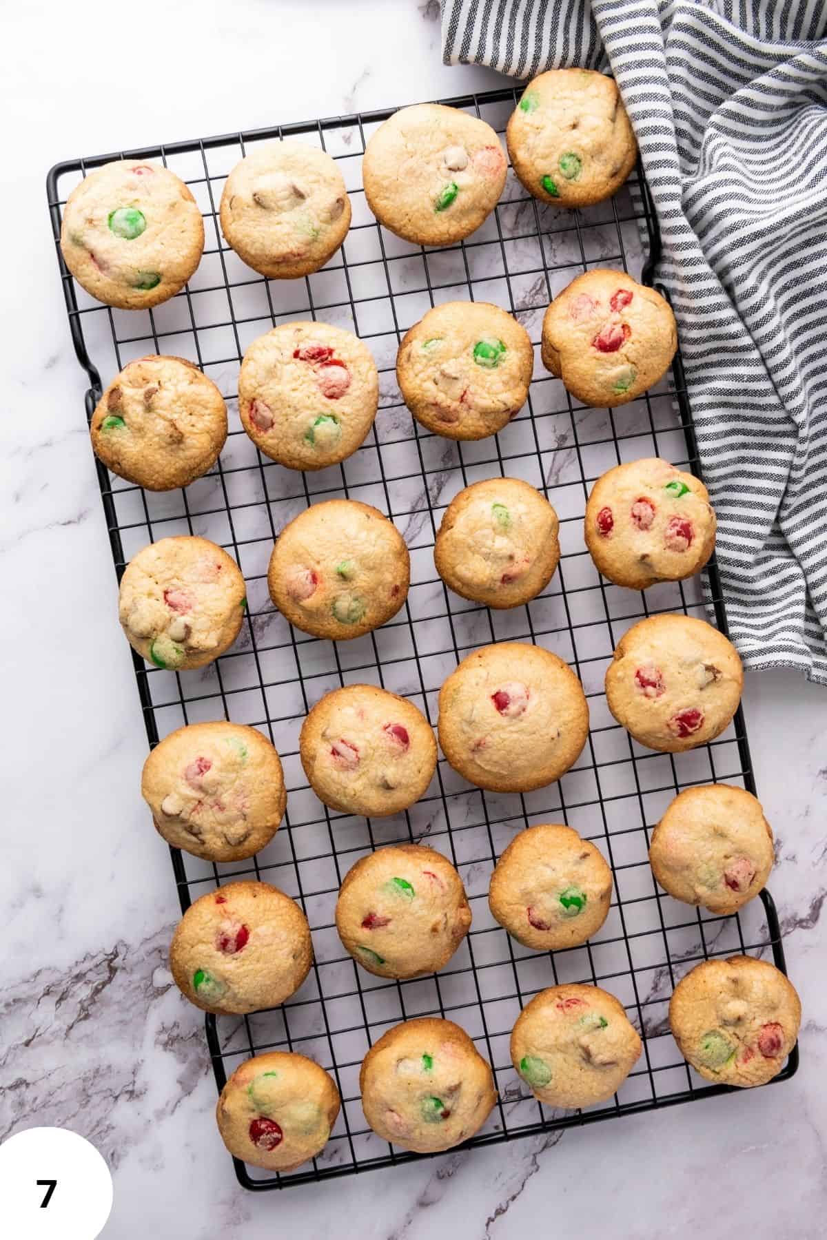 reshly baked Christmas M&M cookies cooling on a wire rack.