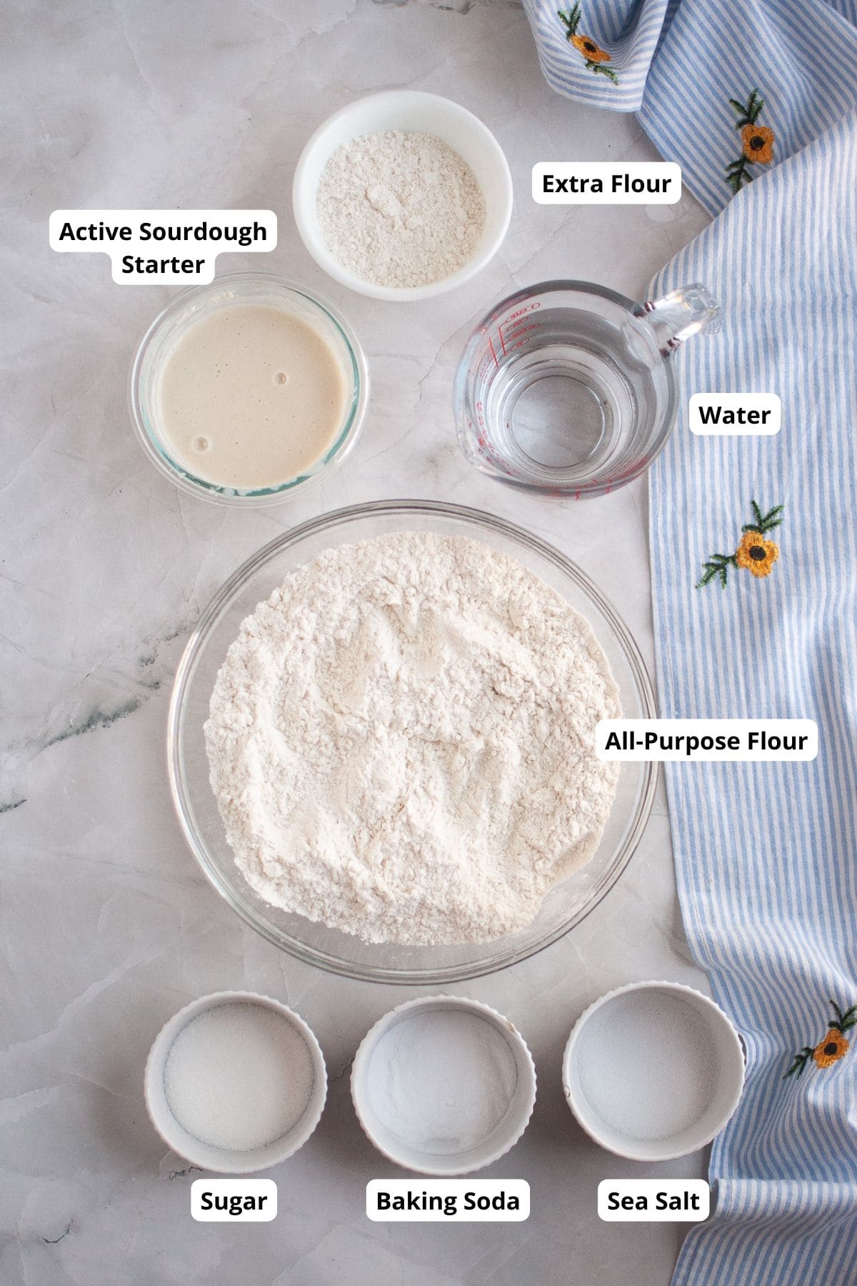 Baking ingredd on a surface in small bowls and a measuring cup.