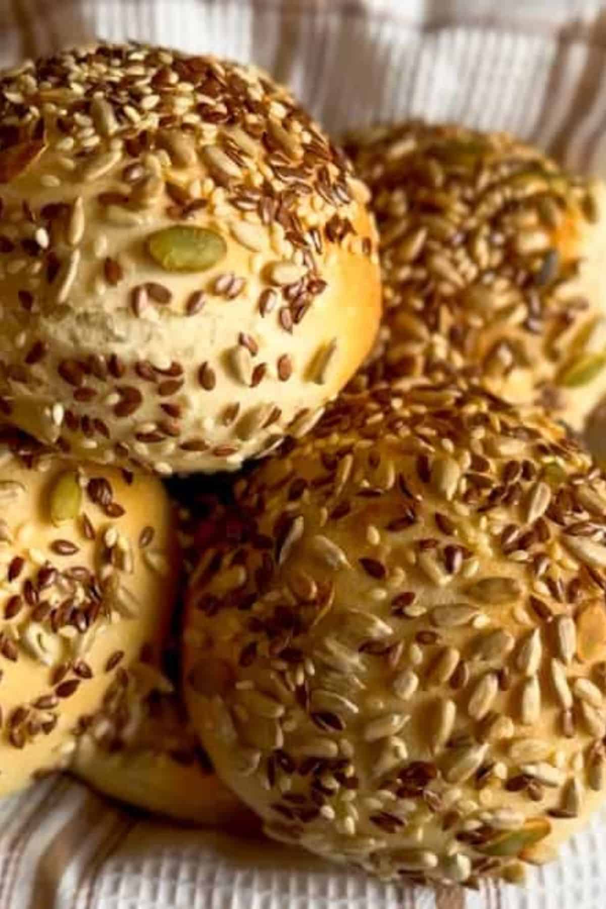 Close-up of stacked yeasted bread rolls, showing their soft, fluffy texture and golden-brown crust.