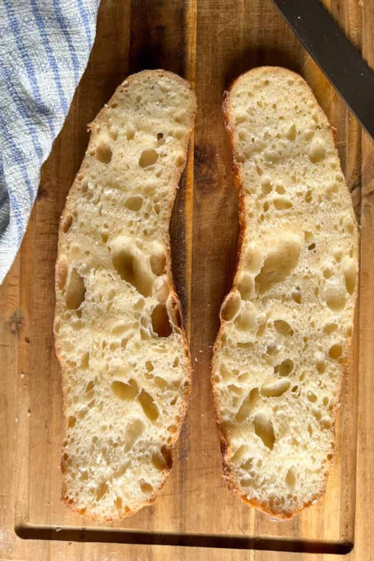 Artisan sourdough bread, open crumb, handmade, bakery fresh, crusty loaf.