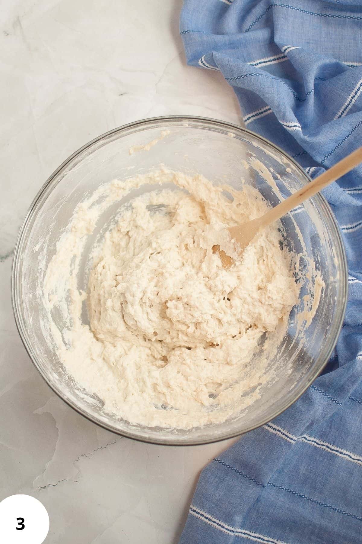 Mixture in a large mixing bowl with a spatula resting on top.