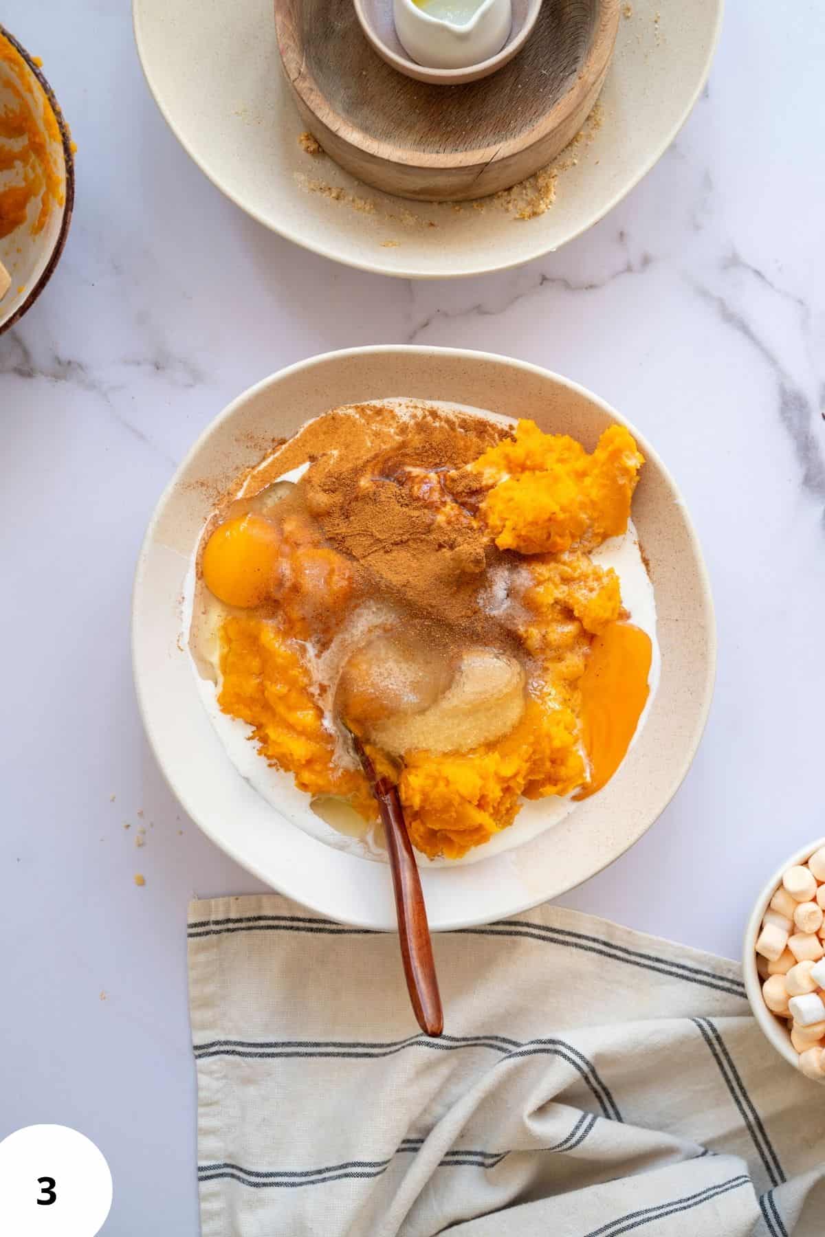 Ingredients being mixed in a medium bowl with other ingredients on the side.