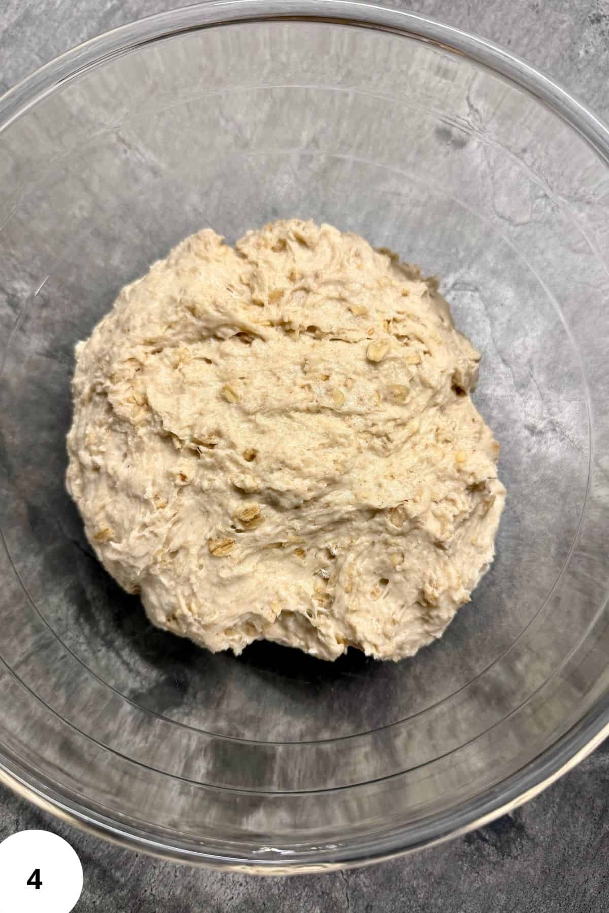 A ball of dough resting in a bowl