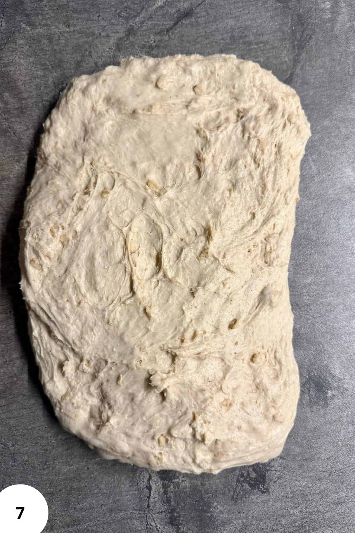 Dough flattened on a smooth surface.