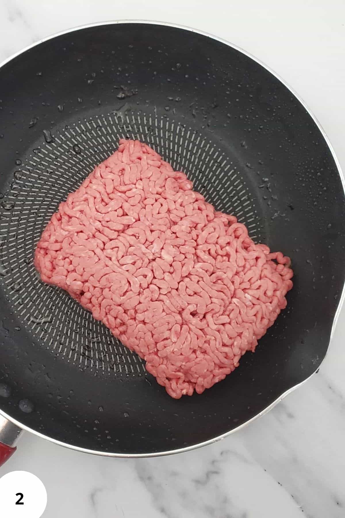 Ground beef in a skillet.
