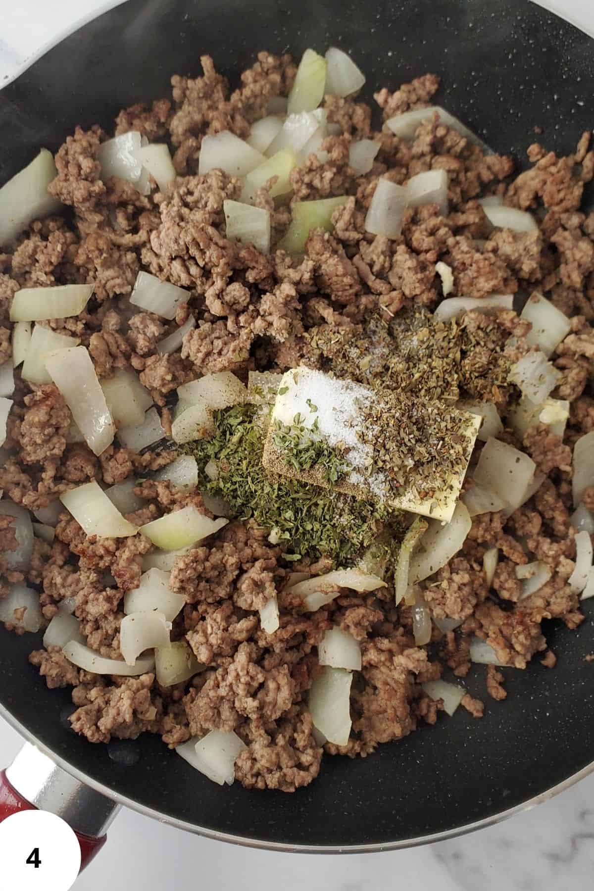 A pot filled with ingredients being seasoned, ready for cooking.