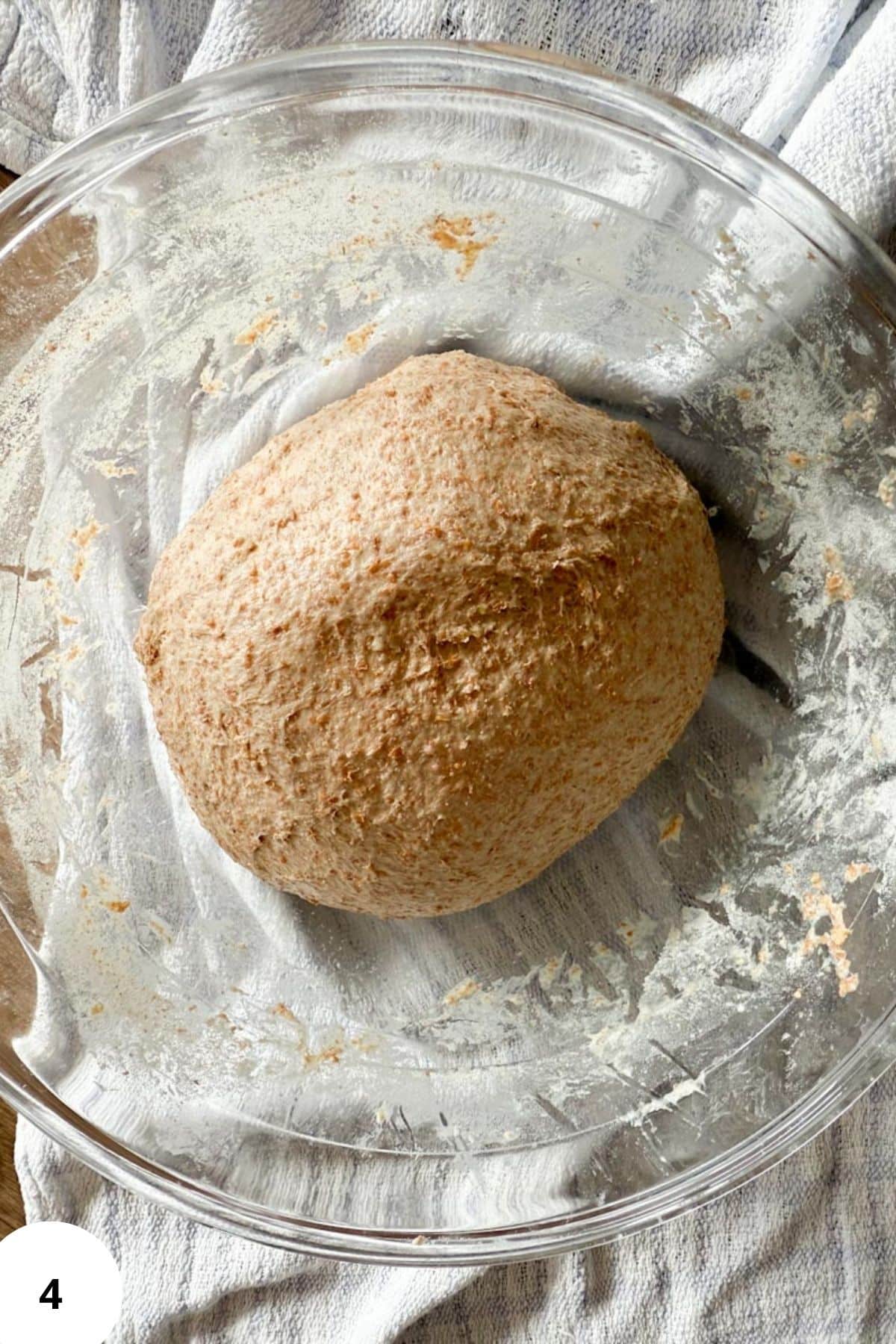 Soft ball of sourdough dough nestled in a bowl, ready for its final rise.