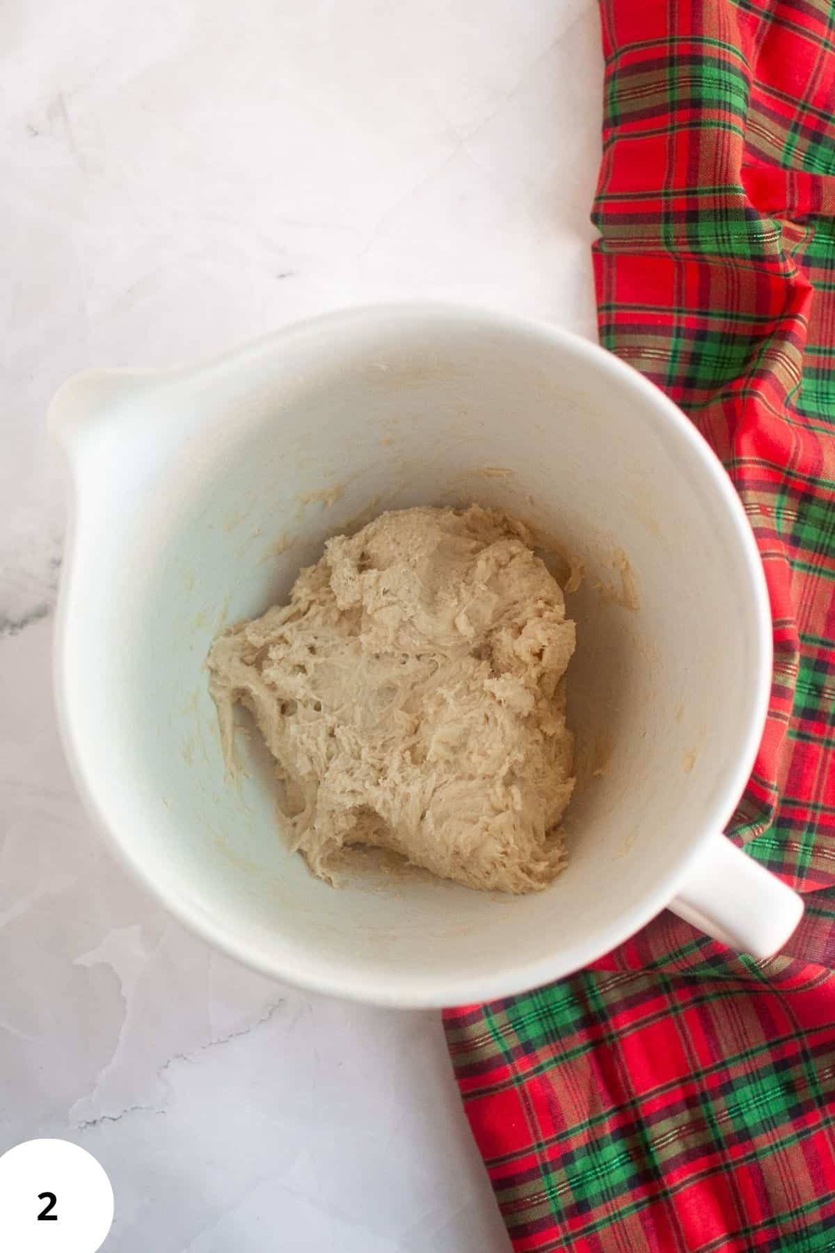 Bread dough resting in a mixer.