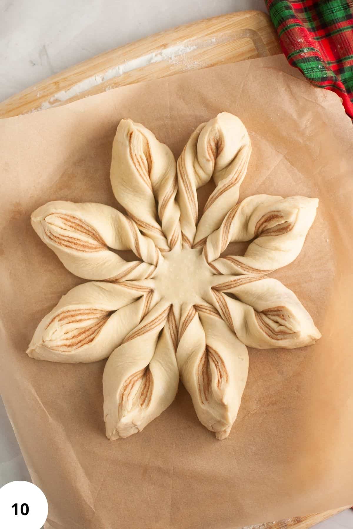 Unbaked star bread on a baking tray lined with parchment paper.