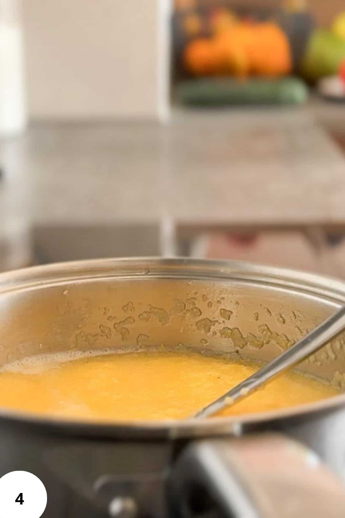 Close-up of bread dough during stretch and fold process in a mixing bowl.