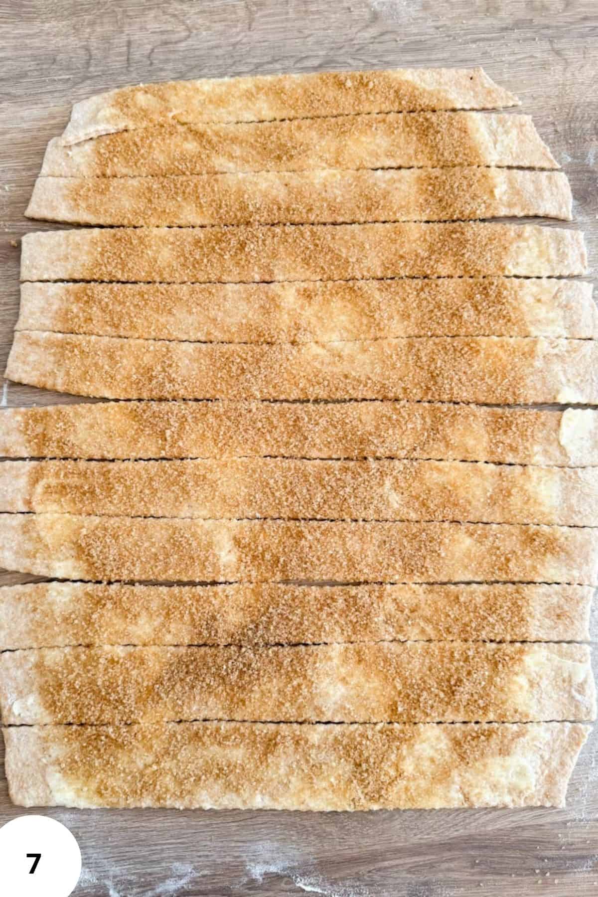 Strips of whole grain sourdough dough with rich cinnamon-sugar filling spread across the surface.