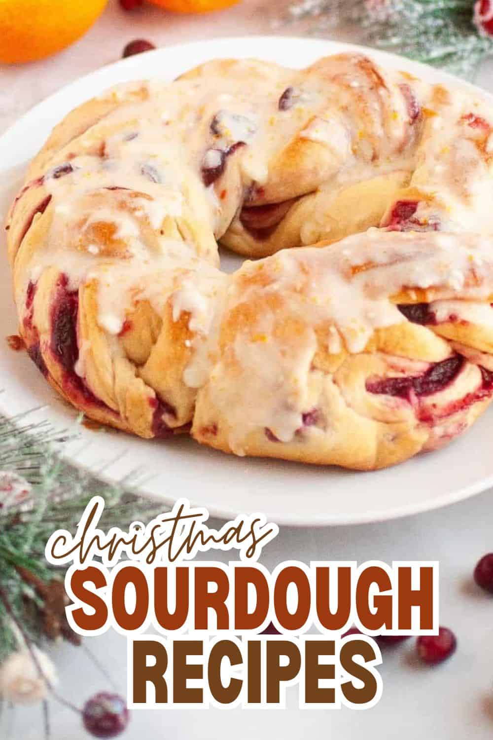 Christmas sourdough bread with cranberries and glaze on a white plate.