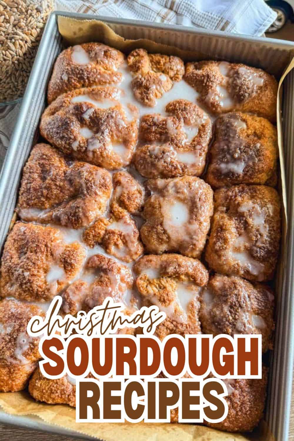 Golden brown sourdough bread with icing sugar in a baking tray for Christmas.