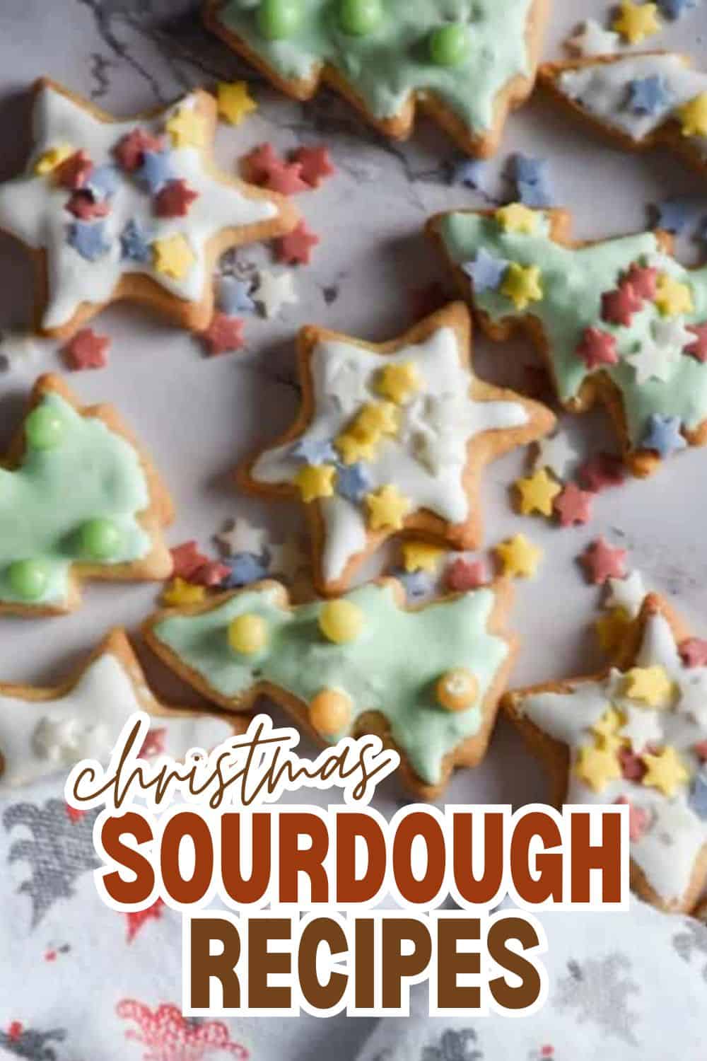 Decorated Christmas sourdough cookies with icing and star-shaped sprinkles.