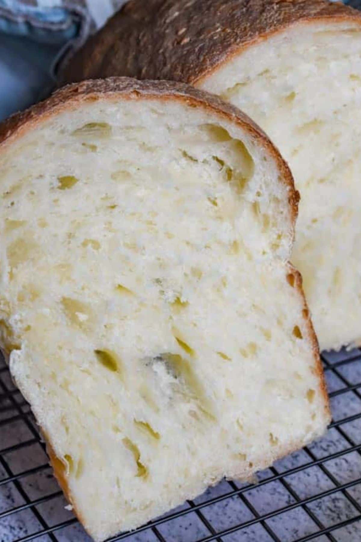 Freshly baked bread showing a light, airy crumb and crust prompted for stretching and folding techniques.