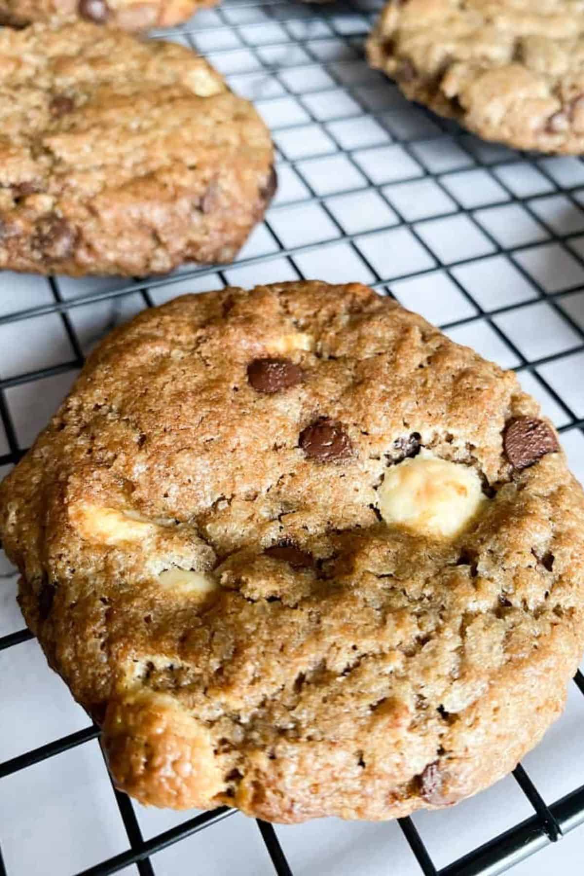 Close-up of sourdough cookies cooling on a wire rack.