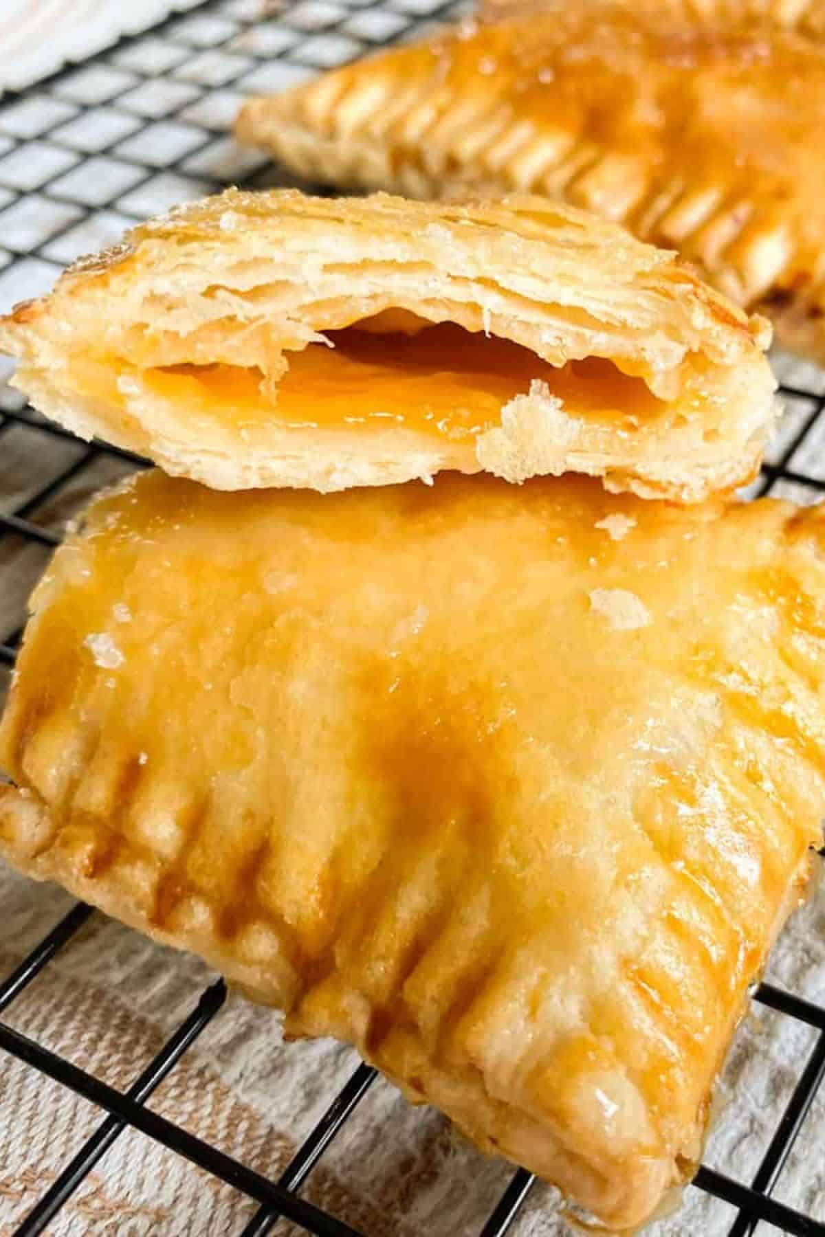 Sourdough discard pop tarts stacked with a bite taken out, showing the jam filling inside.