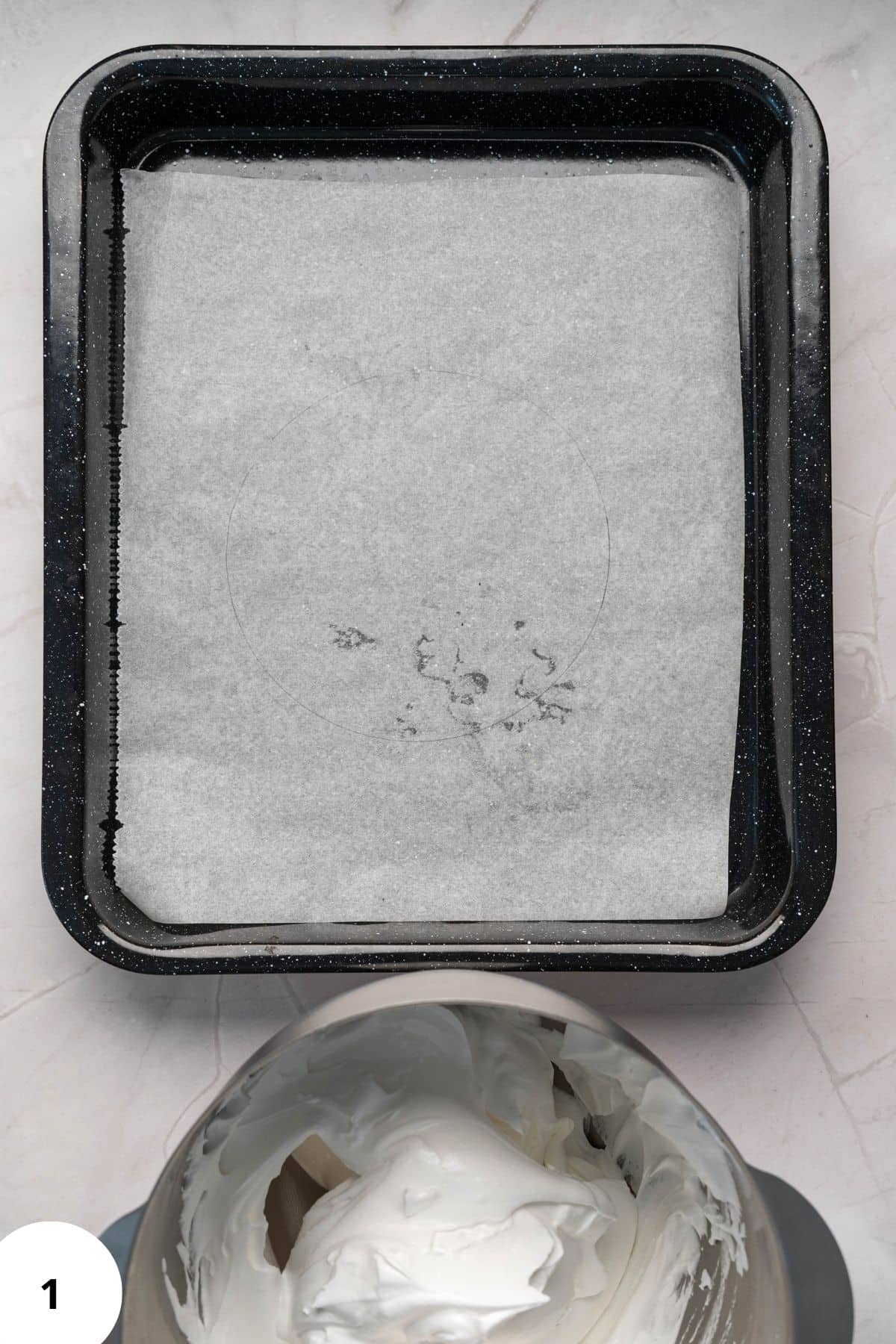 A tray with a parchment paper with mixture on the side.