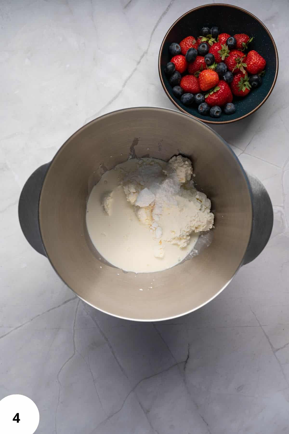 Mixed cream cheese and dairy ingredients in a bowl, prepared for baking or dessert.