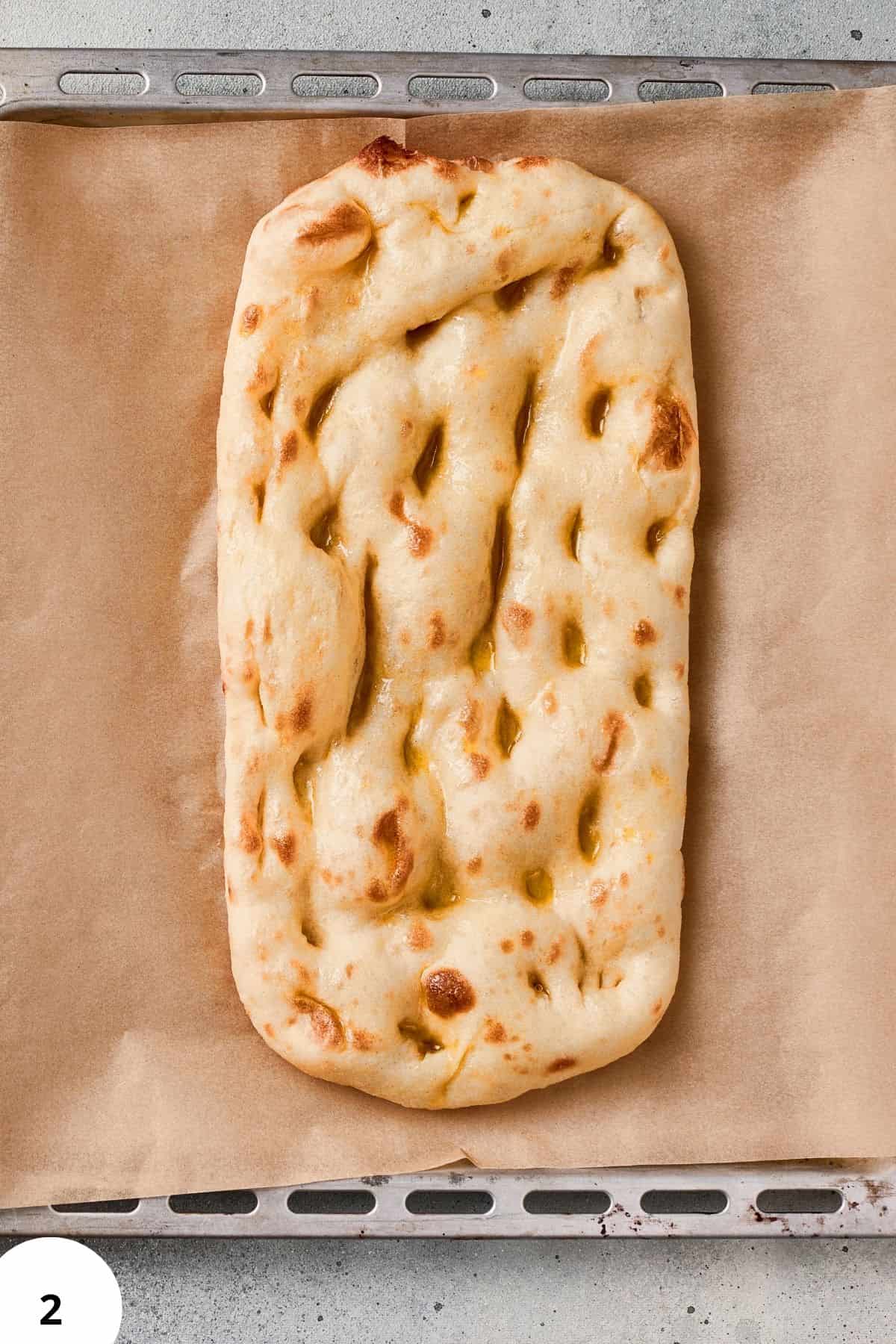 Artisan focaccia bread topped with olive oil, herbs, and a golden crust for baking inspiration.