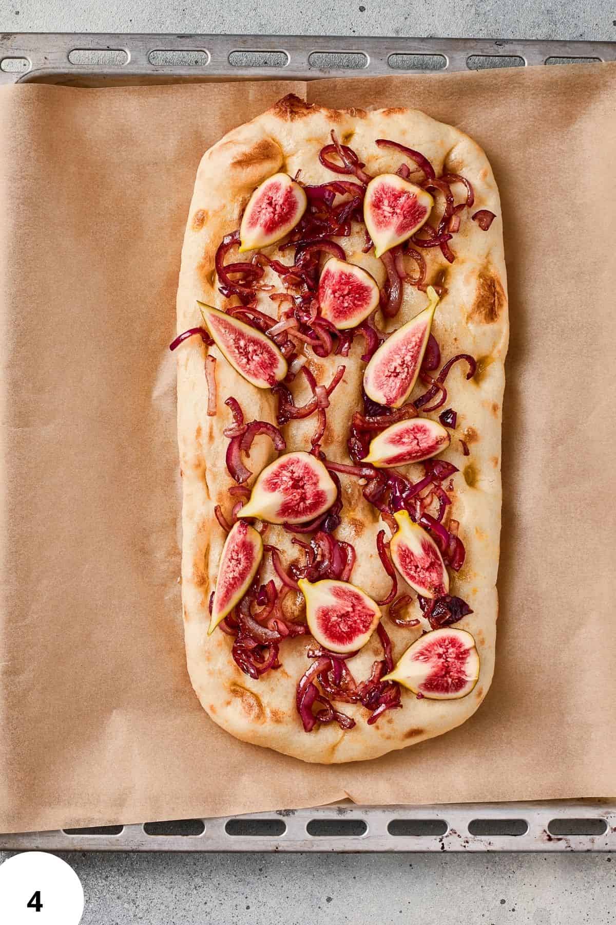 Delicious focaccia bread topped with figs and caramelized onions, showcasing expert bread baking and creative toppings.