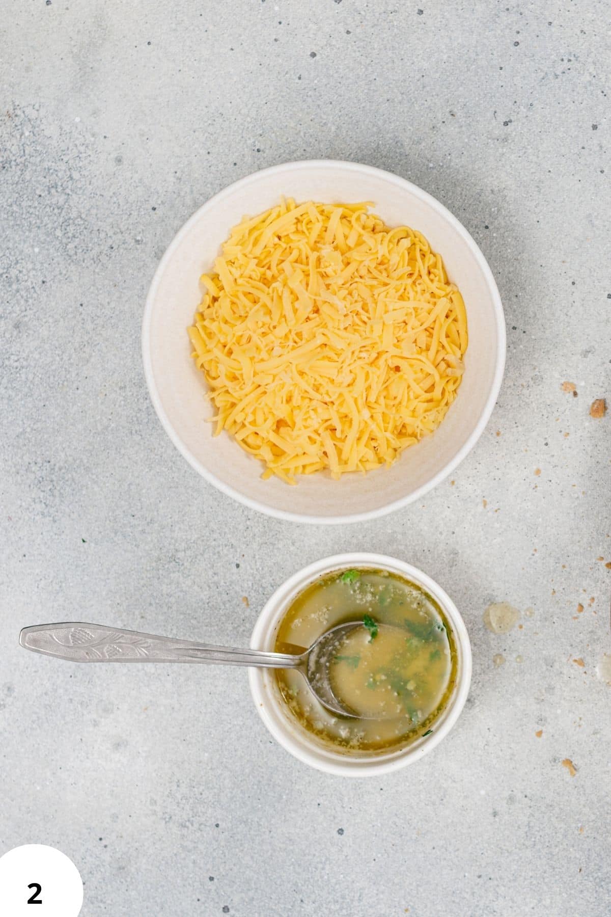 Alt text: Bread dough being stretched on a gray surface, hand folding process for artisan bread.