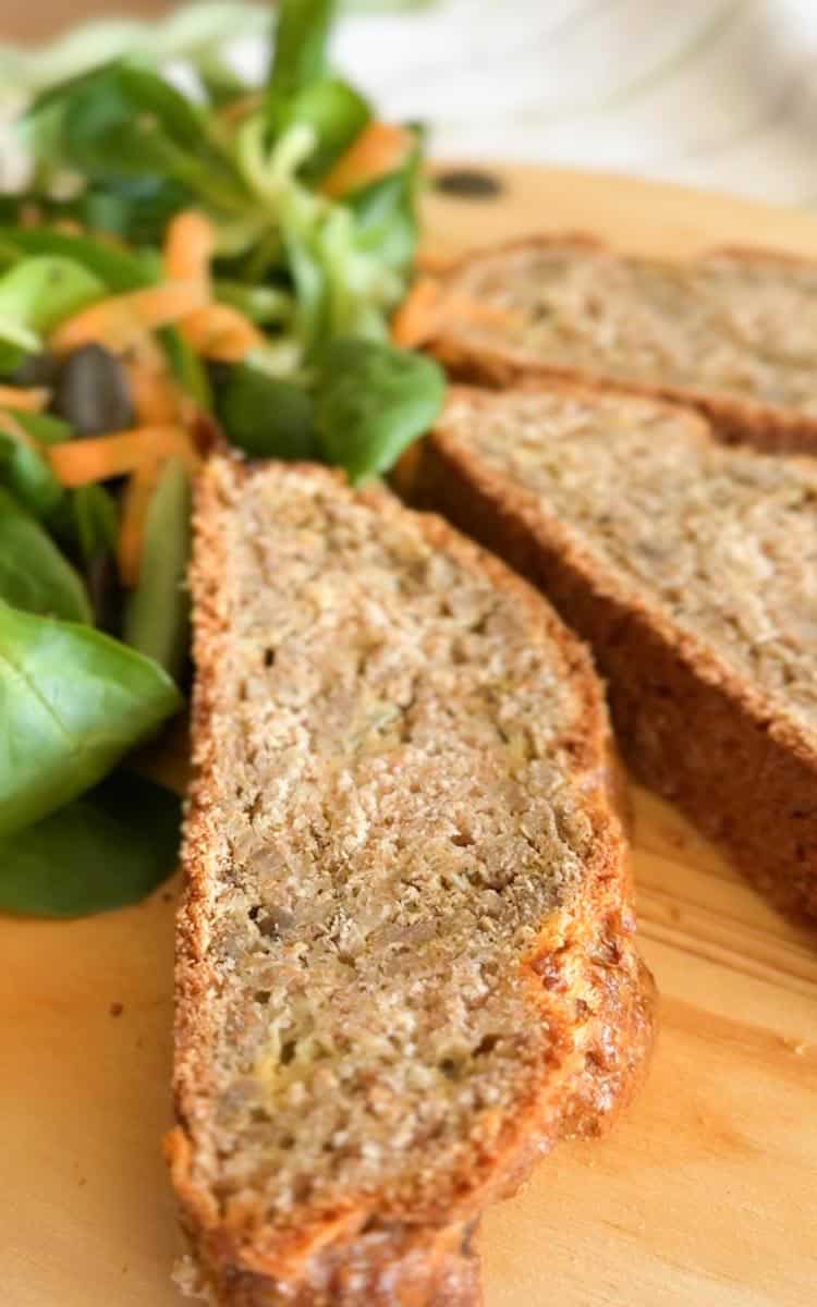 Homemade meat roll made with fresh-milled flour and herbs, sliced for serving.