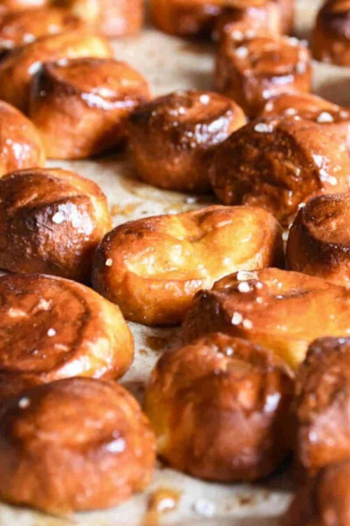 Close-up of sourdough discard pretzel bites arranged on parchment paper.