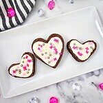 Decorated cookies with white chocolate, sprinkles, and candy hearts for baking lovers.