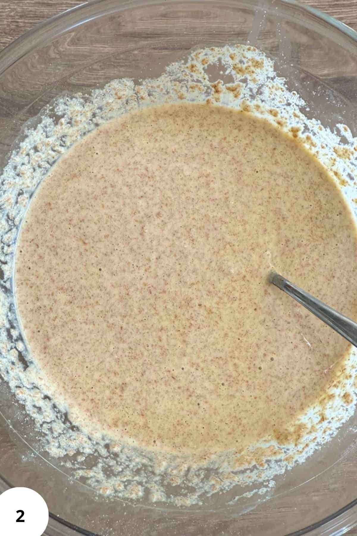Close-up of a smooth, freshly mixed batter made from freshly milled grains in a glass mixing bowl.