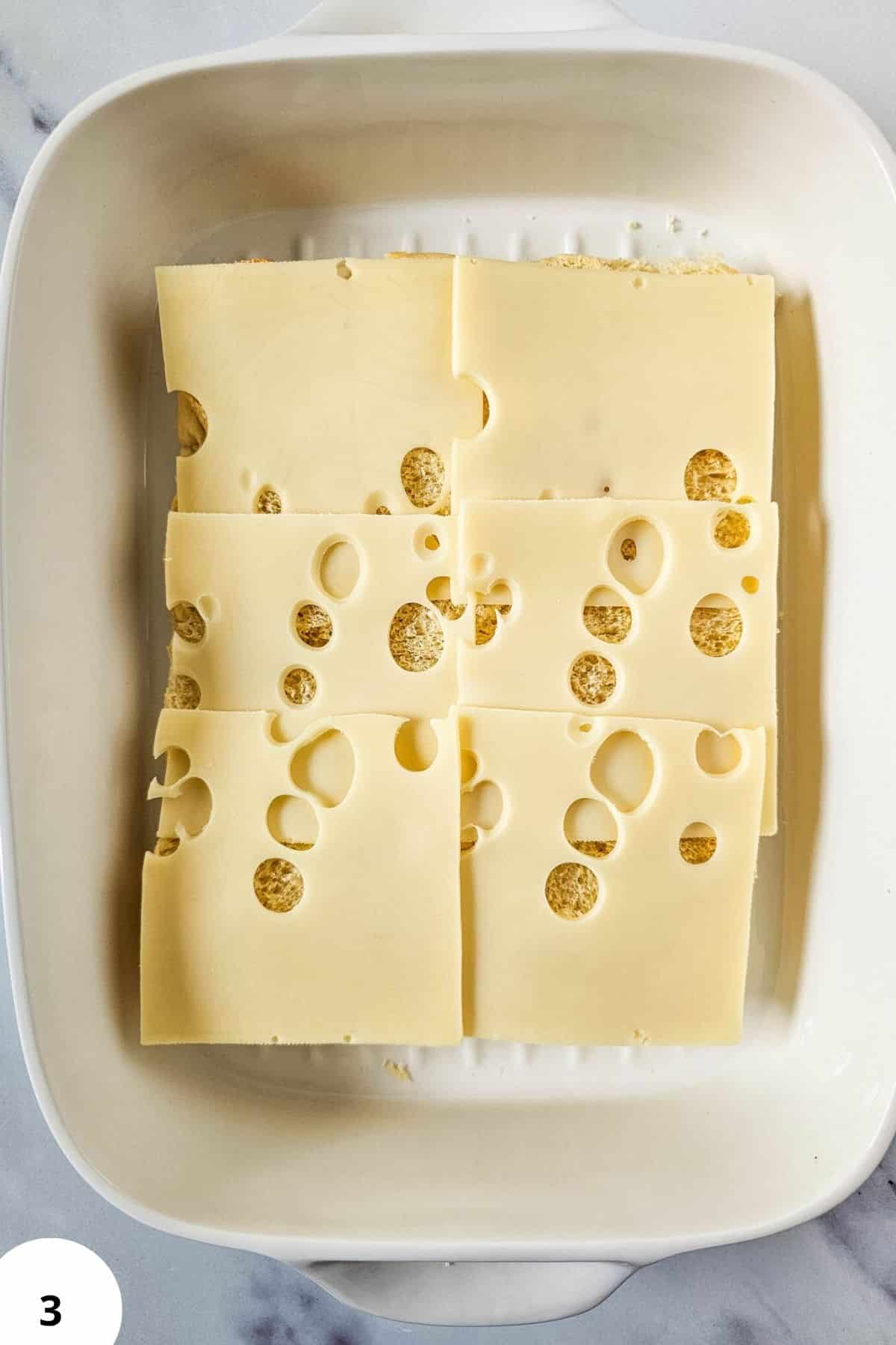 Cheese slices with characteristic holes, highlighting the dough's stretch and fold process in bread baking.