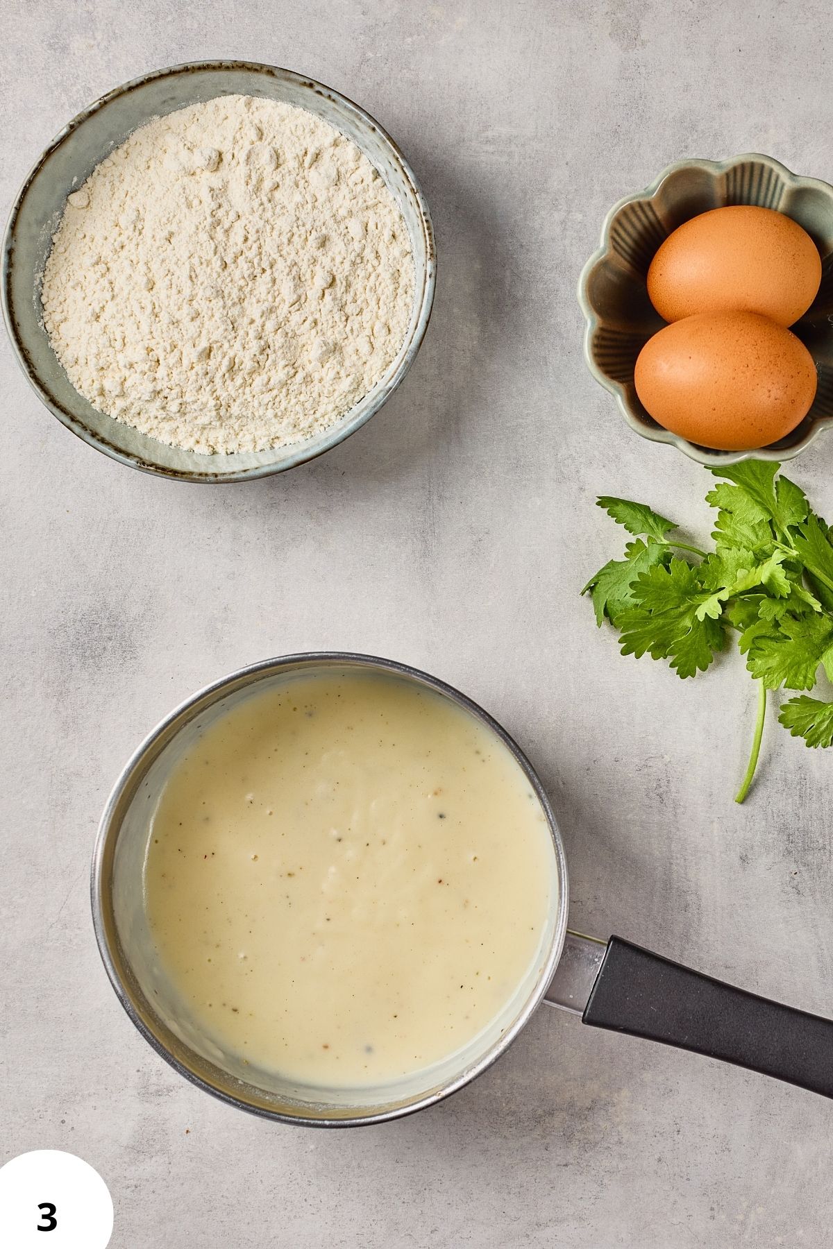 Mixing flour, eggs, and cilantro for bread dough.