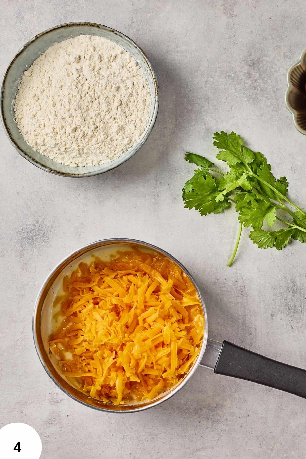 Freshly grated cheese, flour, and herbs for homemade bread.